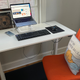 I just slide the anti-fatigue mat underneath and roll my chair up when I’m ready to sit.
